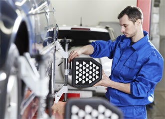 Service Technician Looking at Vehicle
